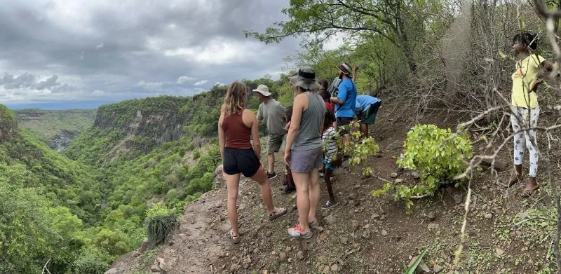 Hikers inside a deep red-rock canyon